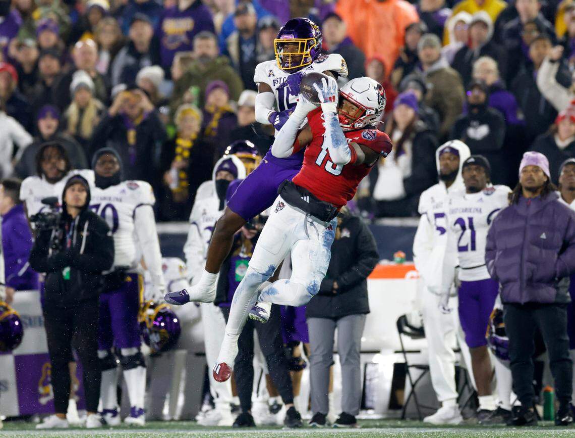 N.C. State cornerback Tamarcus Cooley (15) intercepts the ball intended for East Carolina wide receiver Yannick Smith (15) during the second half of ECU’s 26-21 victory over N.C. State in the Military Bowl at Navy-Marine Corps Memorial Stadium in Annapolis, Md., Saturday, Dec. 28, 2024.
