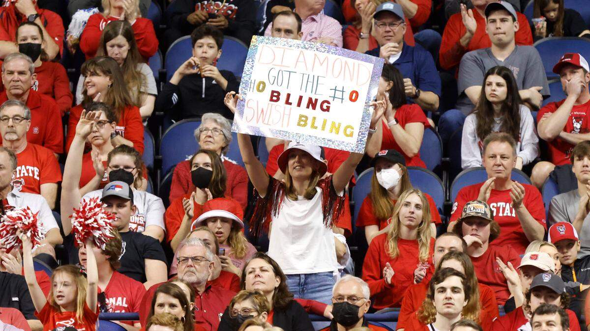 Fans cheer on N.C. State’s Diamond Johnson during the first half of N.C. State’s game against Miami in the championship of the ACC women’s basketball tournament in Greensboro, N.C., Sunday, March 6, 2022.