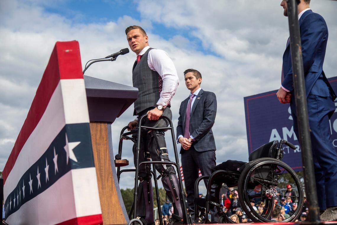 U.S. Rep Madison Cawthorn stands with the aid of a walker during a rally with former President Donald Trump in Selma Saturday, April 9, 2022. Cawthorn was cited for having a gun at a TSA checkpoint at Charlotte Douglas International Airport on Tuesday morning, April 26, 2022, WSOC reported.