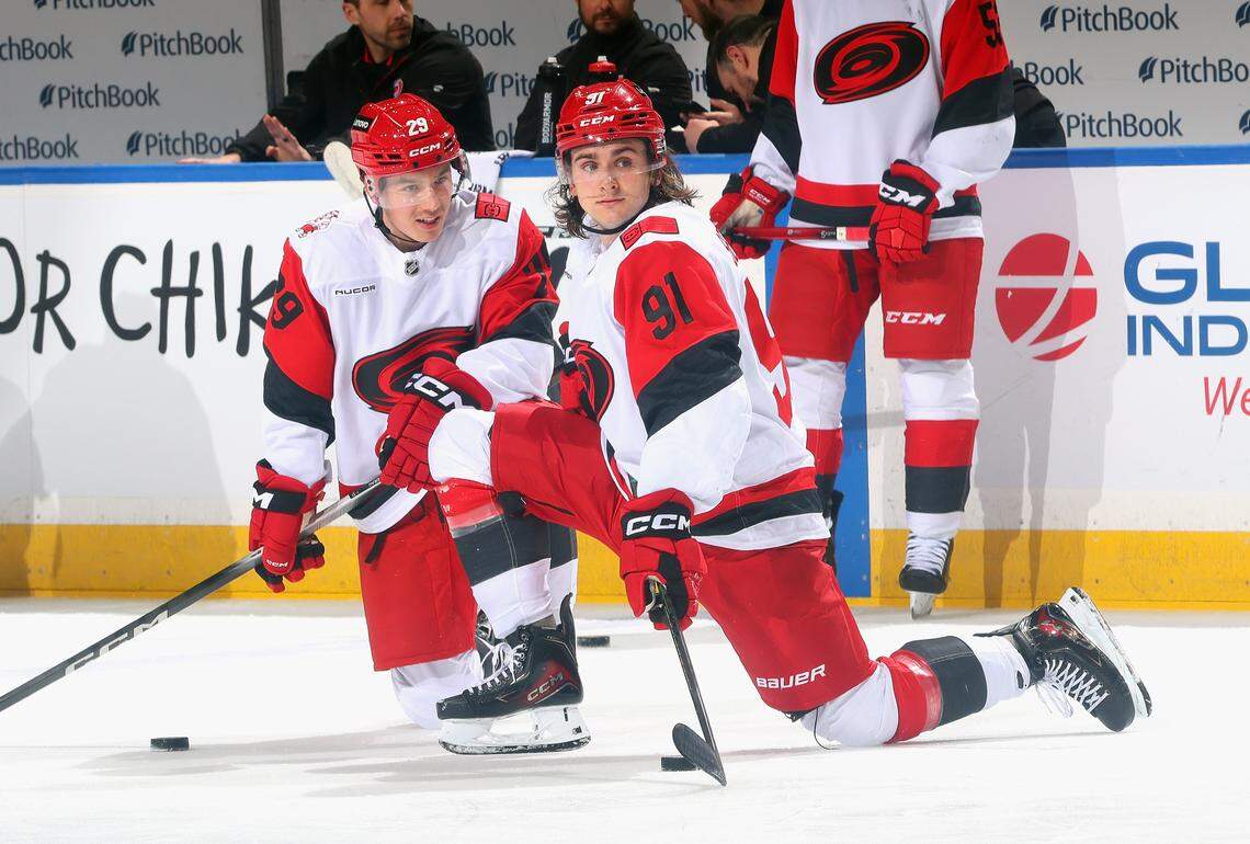 Bradly Nadeau, left, and Ronan Seeley of the Carolina Hurricanes chat during warmups prior to the game against the New York Islanders at UBS Arena on April 14, 2026 in Elmont, New York.