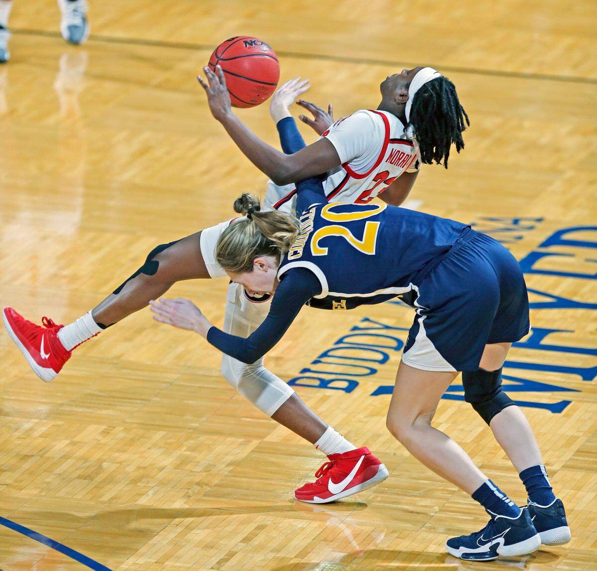 Drexel forward Kate Connolly (20) fouls Georgia guard Que Morrison (23) going for a pass during the first half of a college basketball game in the first round of the women’s NCAA tournament at the Greehey Arena in San Antonio, Texas, Monday, March 22, 2021. 