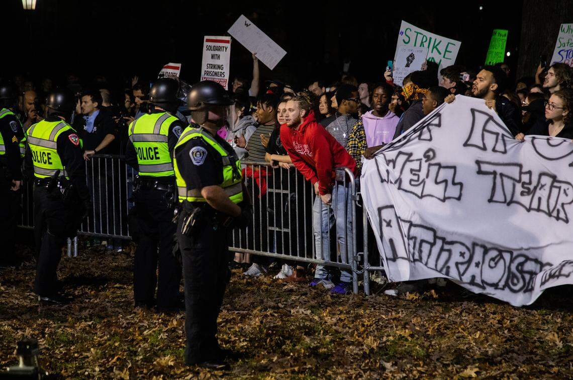 Several hundred demonstrators face off with police at a barricade around the boarded up base of the Silent Sam Confederate statue at UNC-Chapel Hill on Monday night.
