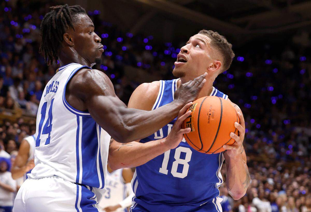 Duke’s Mason Gillis (18) looks to shoot as Sion James (14) defends during a scrimmage during the Blue Devils’ Countdown to Craziness at Cameron Indoor Stadium in Durham, N.C., Friday, Oct. 4, 2024.