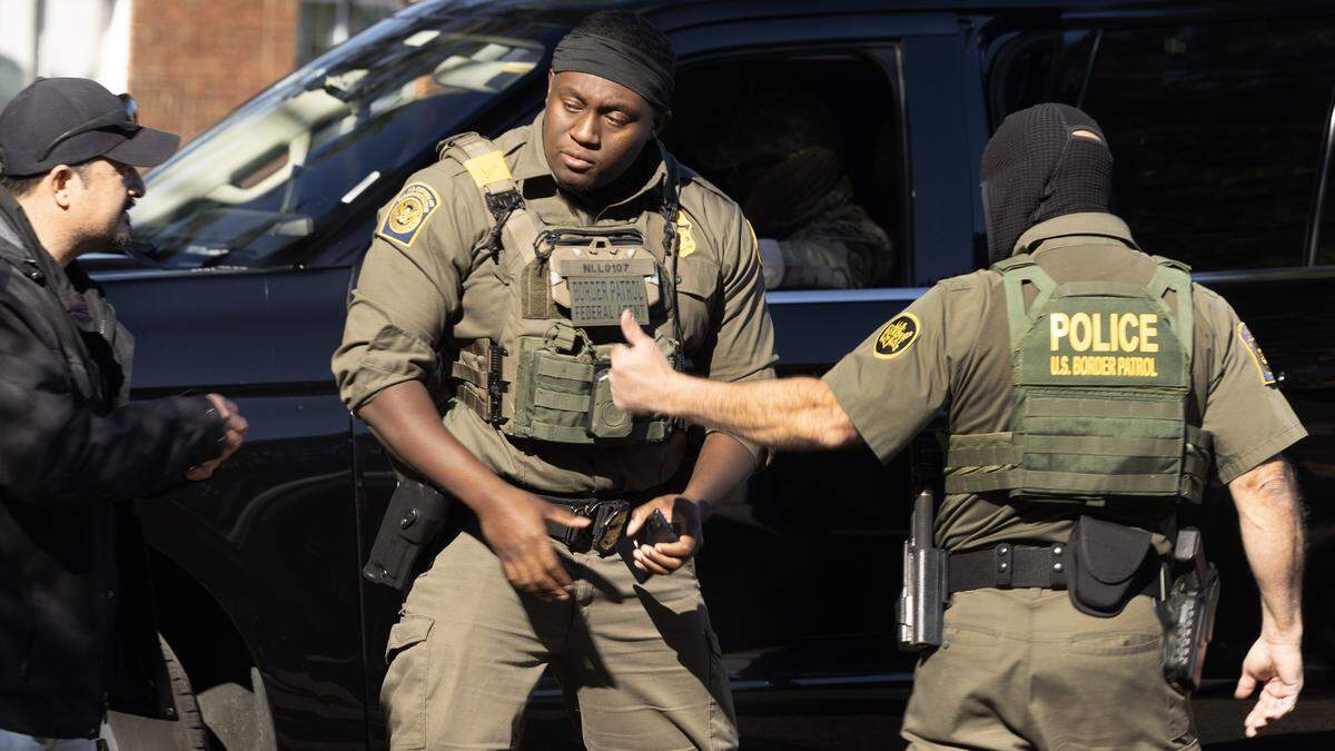 A Border Patrol agent gives a man a thumbs up after checking his identification on Fox Ridge Drive in Southeast Raleigh, N.C. Tuesday, Nov. 18, 2025.  The man was not taken into custody.