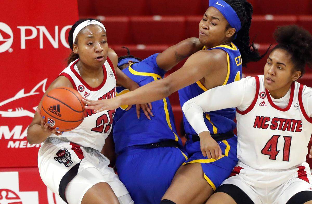 N.C. State’s Kayla Jones (25) pulls the rebound from Pittsburgh’s Cynthia Ezeja (14) during the first half of N.C. State’s game against Pittsburgh at Reynolds Coliseum in Raleigh, N.C., Thursday, February 25, 2021.