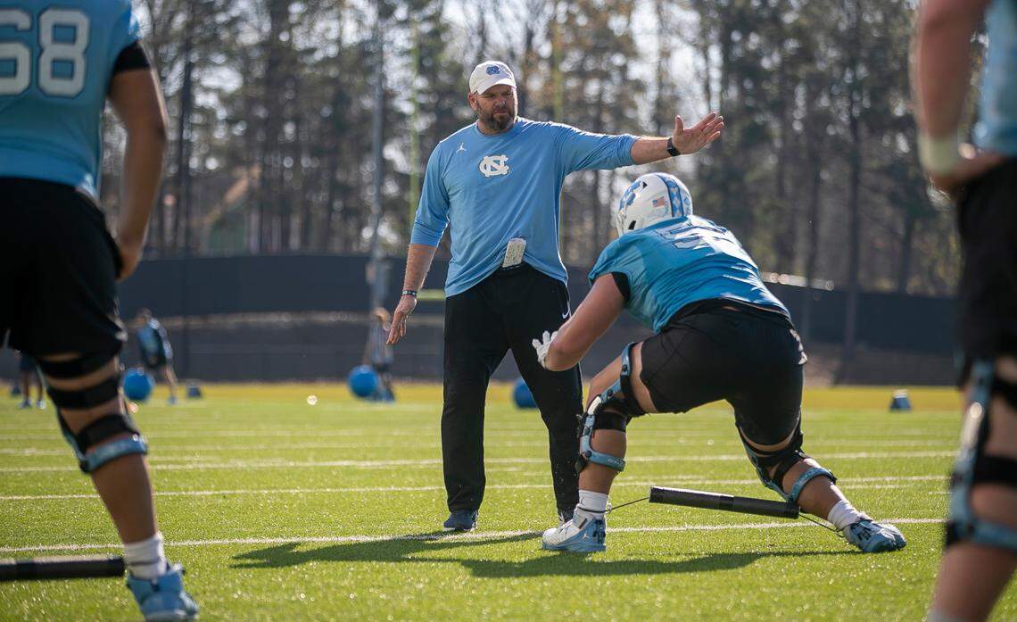 North Carolina offensive line coach Randy Clements works with Jonathan Adorno (52) during the Tar Heels’ practice on Tuesday, March 7, 2023 in Chapel Hill, N.C.