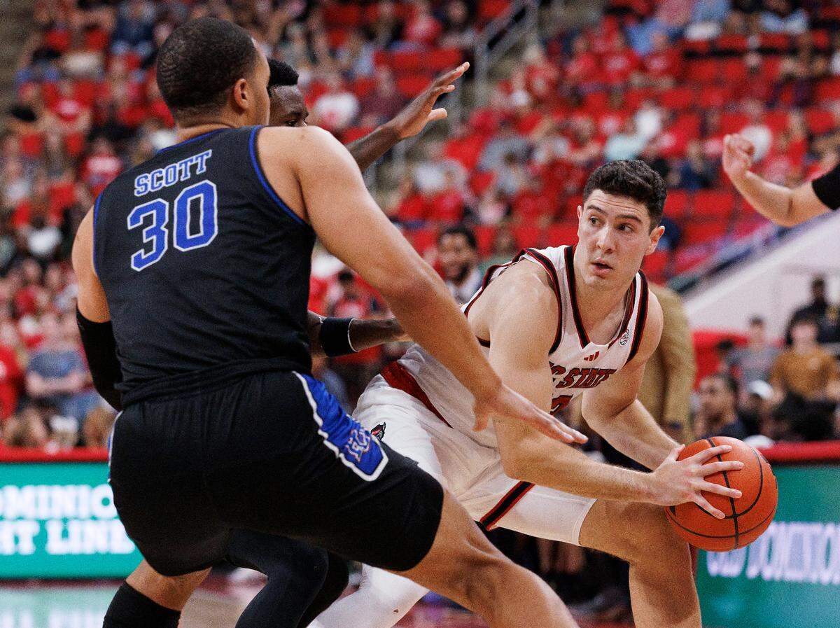 N.C. State’s Michael O’Connell looks to pass around Presbyterian’s Kory Mincy and Kaleb Scott during the second half of the Wolfpack’s 81-72 win on Friday, Nov. 8, 2024, at Lenovo Center in Raleigh, N.C.