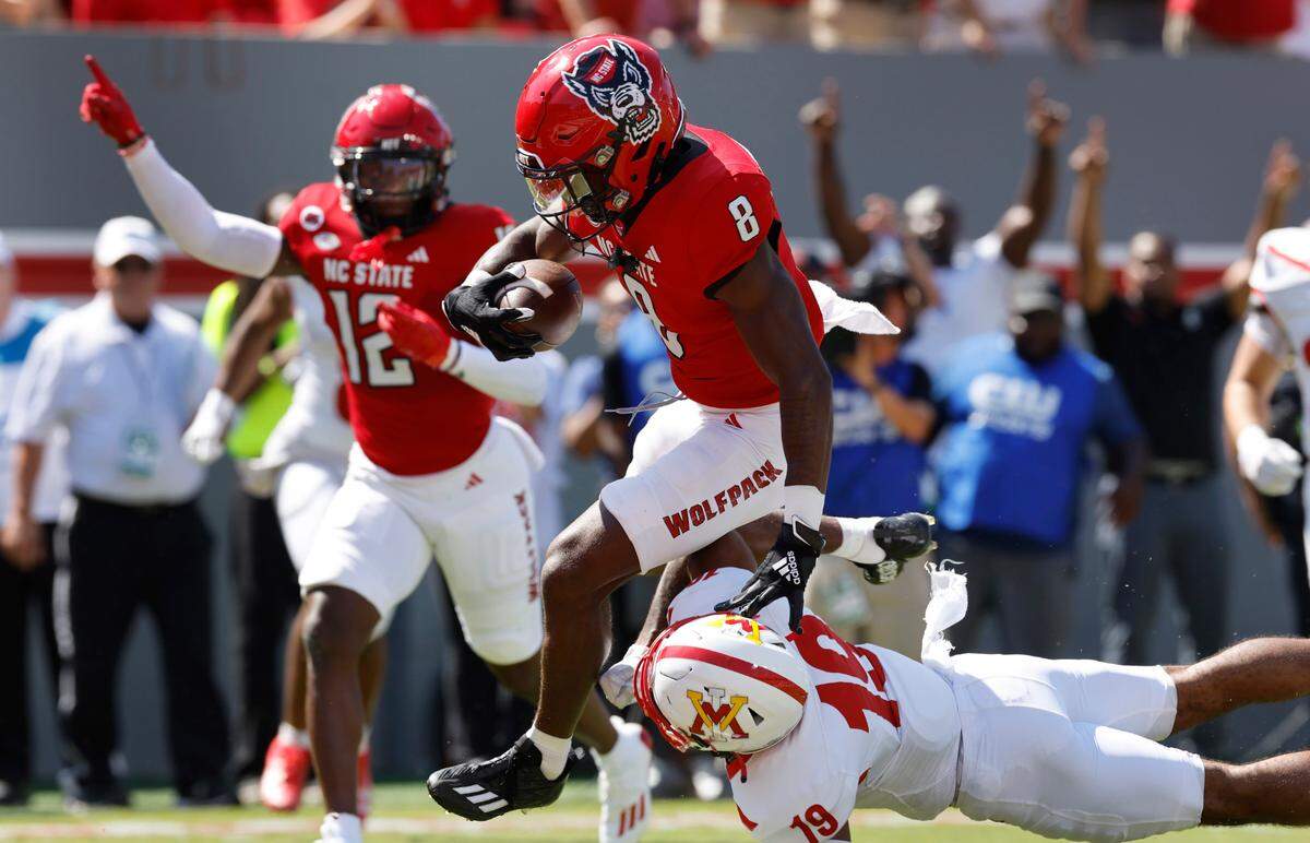 N.C. State defensive back Robert Kennedy (8) beats Virginia Military Institute defensive back Wilson Chandler (19) as he returns an interception for a touchdown during the first half of N.C. State’s game against VMI at Carter-Finley Stadium in Raleigh, N.C., Saturday, Sept. 16, 2023.
