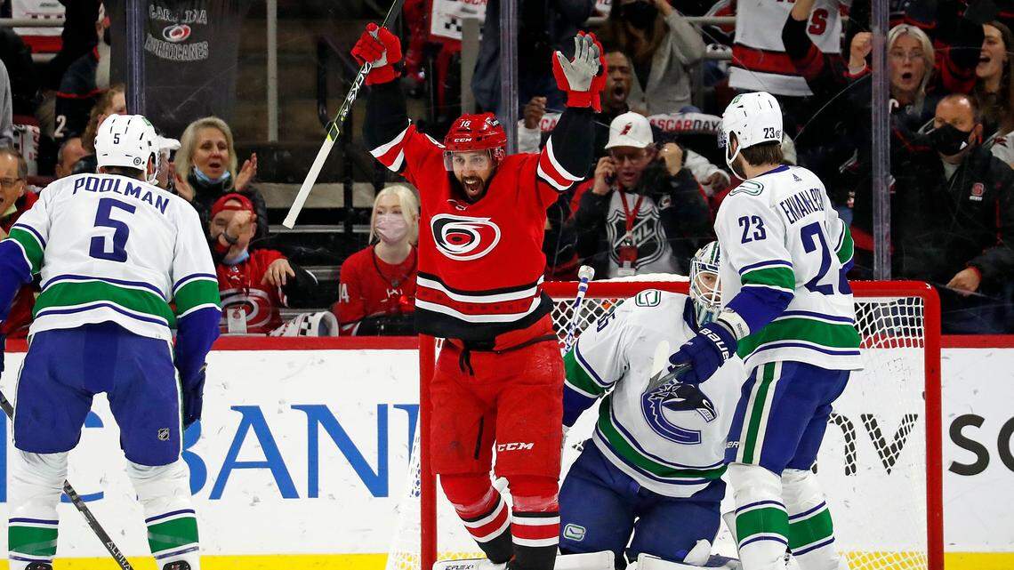 Carolina Hurricanes’ Vincent Trocheck (16) celebrates a goal by teammate Sebastian Aho, not pictured, against the Vancouver Canucks during the first period of an NHL hockey game in Raleigh, N.C., Saturday, Jan. 15, 2022. (AP Photo/Karl B DeBlaker)