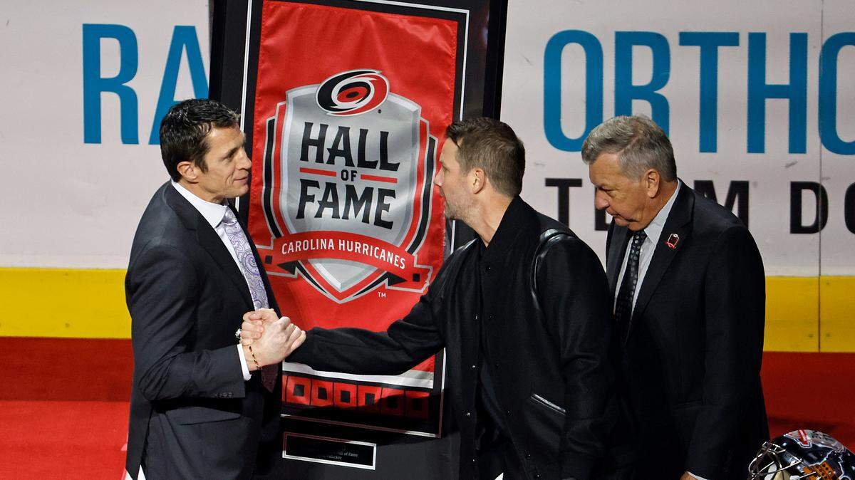 Carolina Hurricanes head coach Rod Brind’Amour, left, congratulates former Hurricanes goalie Cam Ward on Ward’s induction into the Hurricanes Hall of Fame prior to an NHL hockey game against the Montreal Canadiens in Raleigh, N.C., Thursday, Feb. 16, 2023.