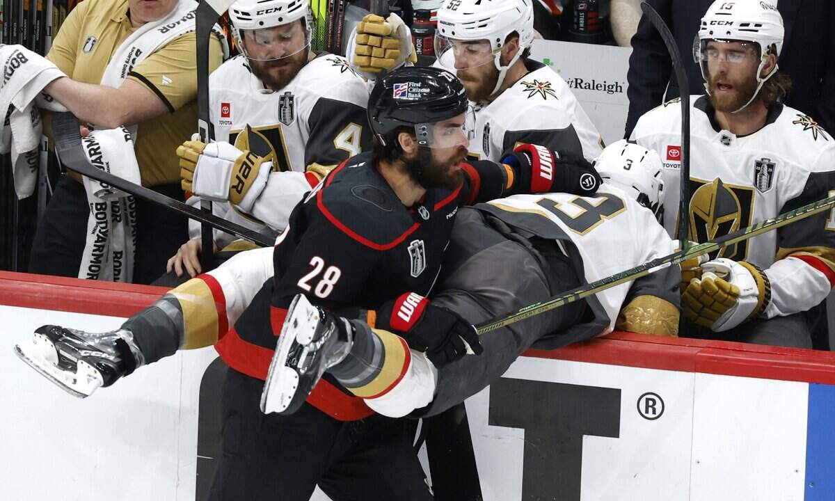 Carolina's William Carrier (28) checks Vegas' Brayden McNabb (3) into the bench in the first period of the Hurricanes’ game against the Golden Knights in the fifth game of the Stanley Cup Final at the Lenovo Center in Raleigh, N.C., Thursday, June 11, 2026.