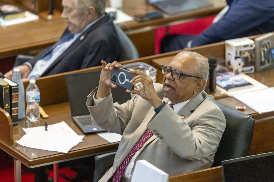 Rep. Nasif Majeed photographs the vote count on Senate Bill 249 following its passage on Wednesday, October 22, 2025 at the General Assembly in Raleigh, N.C.