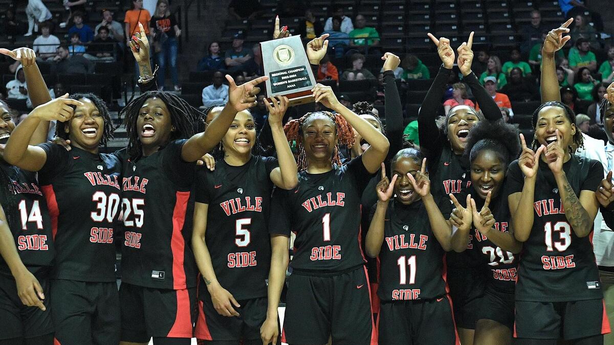Rolesville’s Caitlyn Jones (5) , Taliya Rowe (1) hold the 4A East Regional Championship trophy and celebrate with teammates after their victory over Hoggard. Rolesville and Hoggard met in the NCHSAA 4A East Regional Championship game in Winston-Salem, N.C. on March 14, 2024.