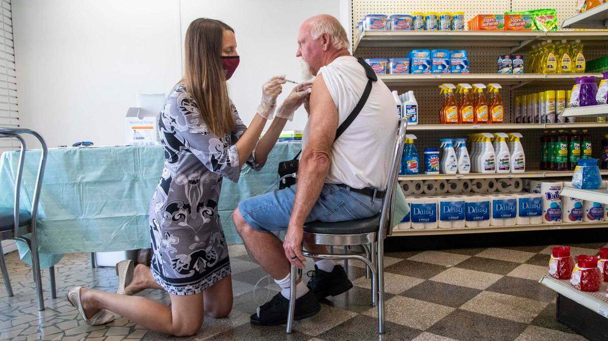 Dr. Stephanie Bellows prepares to administer a COVID-19 vaccine to Earl Nealey, 59, at Guiton’s Drug Store in Whiteville Thursday, July 29, 2021. Columbus County has the state’s highest rate for COVID-19 and one of the lowest for vaccinations. Dr. Bellows vaccinated 38 people on Thursday.