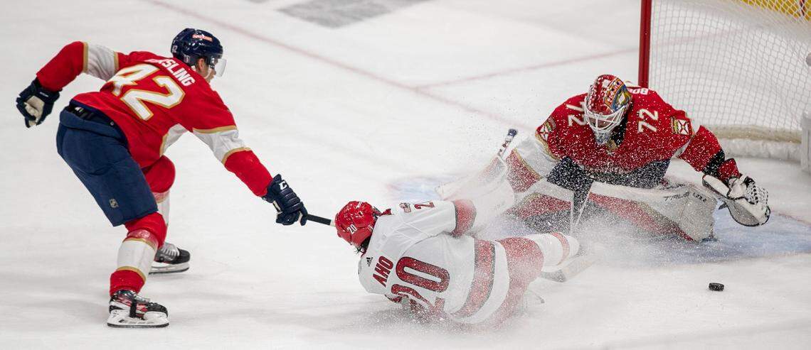 The Carolina Hurricanes Sebastian Aho (20) slides in front of Florida Panthers goalie Sergei Bobrovsky (72) in the first period of Game 3 of the Eastern Conference Finals on Monday, May 22, 2023 at FLA Live Arena in Sunrise, Fla.