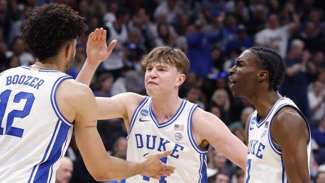 Duke’s Nikolas Khamenia (14) and Dame Sarr (7) celebrate with Cameron Boozer (12) in the first half of Duke’s game against Connecticut in the NCAA Men’s Tournament East Regional Final at Capital One Arena in Washington, D.C., Sunday, March 29, 2026.