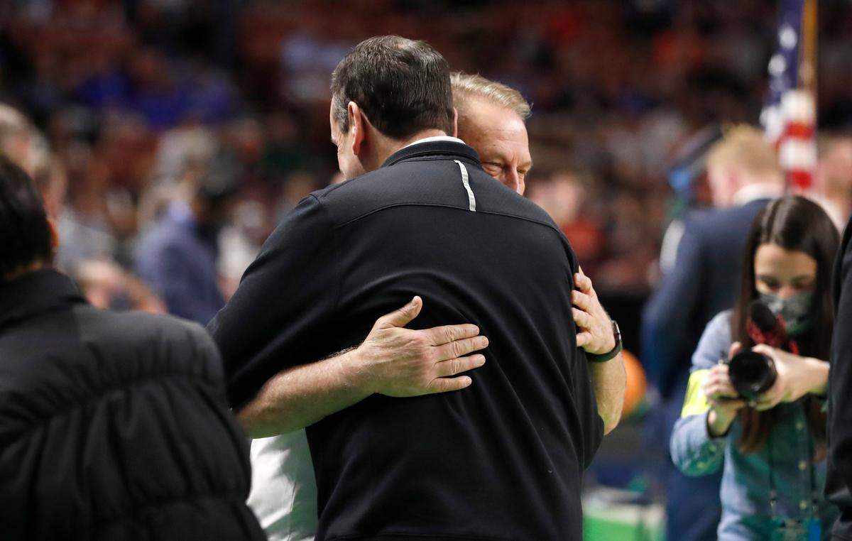 Duke head coach Mike Krzyzewski and Michigan State head coach Tom Izzo hug before Duke’s game against Michigan State in the second round of the NCAA Tournament at Bon Secours Wellness Arena in Greenville, S.C., Sunday, March 20, 2022.