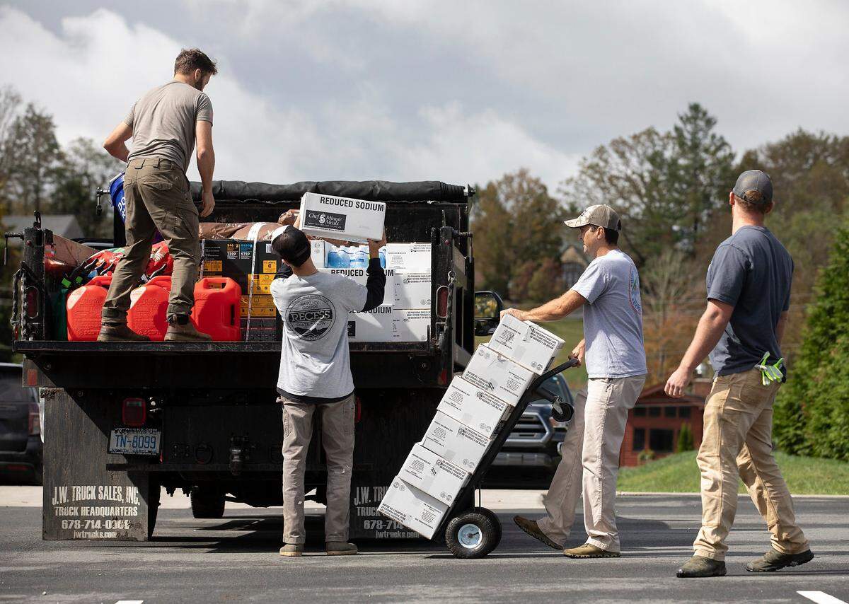 Volunteers load food, clothes and other supplies in Banner Elk, N.C. on Tuesday, Oct. 1, 2024, to be delivered to communities in Avery County impacted by Hurricane Helene.