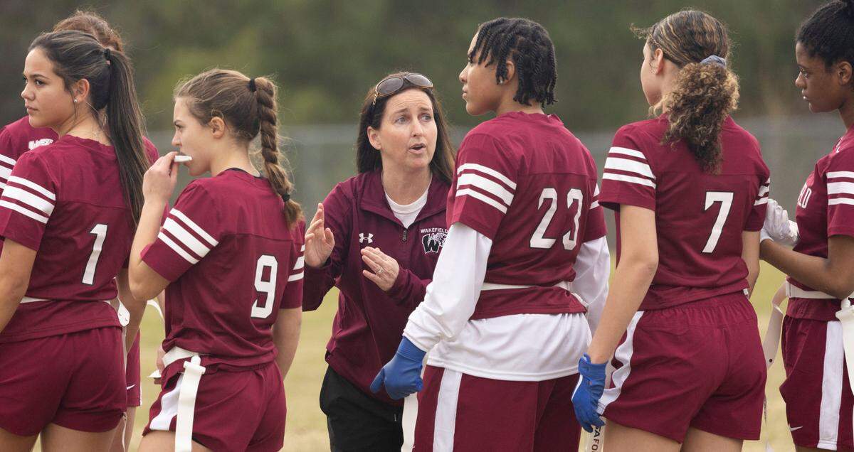 Wakefield High School flag football coach Danielle Blackburn talks to her team during a flag football scrimmage at Heritage High School in Wake Forest, N.C., Wednesday, Jan. 24, 2024.