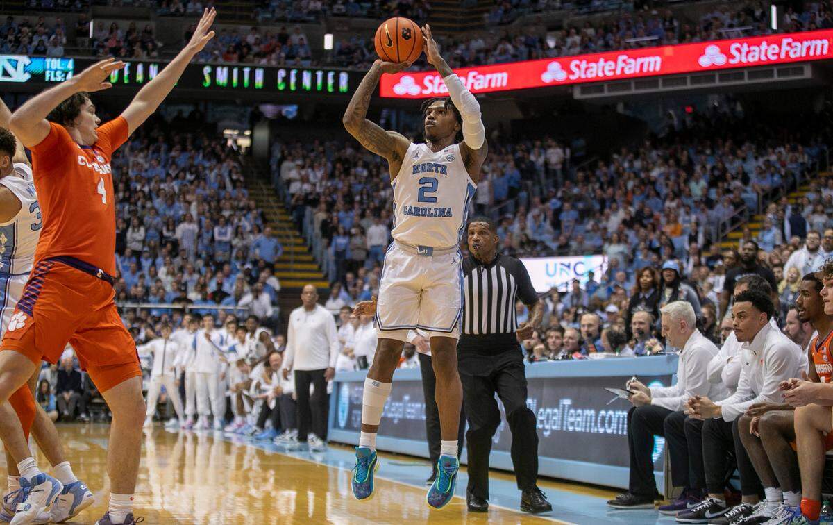 North Carolina’s Caleb Love (2) launches a three point shot in the first half against Clemson on Saturday, February 11, 2023 at the Smith Center in Chapel Hill , N.C. Love lead all scores with 23 points in the Tar Heels’ 91-71 victory.