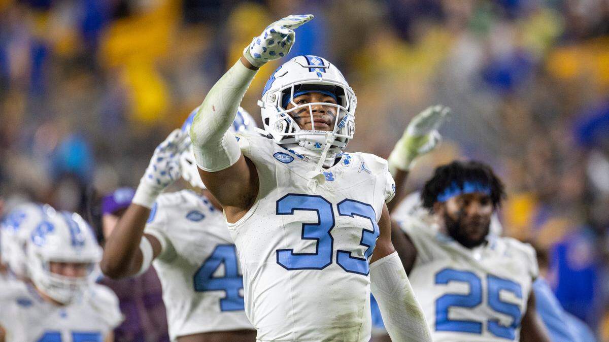 North Carolina’s Cedric Gray (33) and his teammates signal the start of the fourth quarter against Pitt on Saturday, September 23, 2023 at Acrisure Stadium in Pittsburgh, Pa.