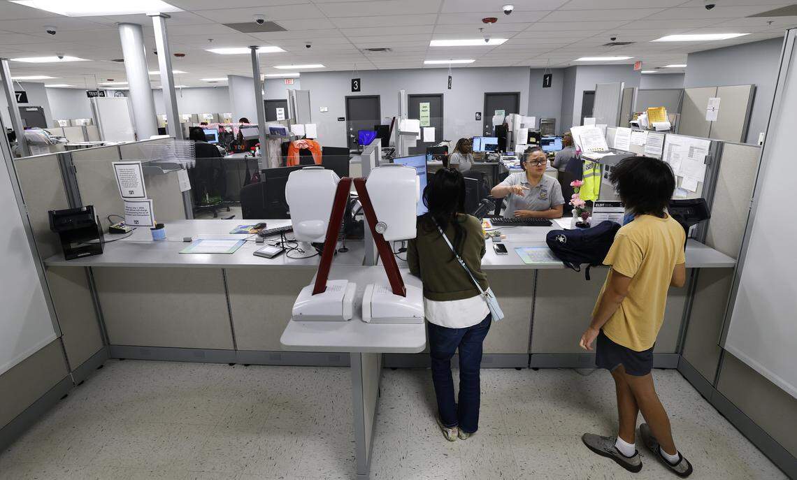 DMV examiner Glenda Brigino helps customers at the East Raleigh Division of Motor Vehicles office Friday, May, 30, 2025. 