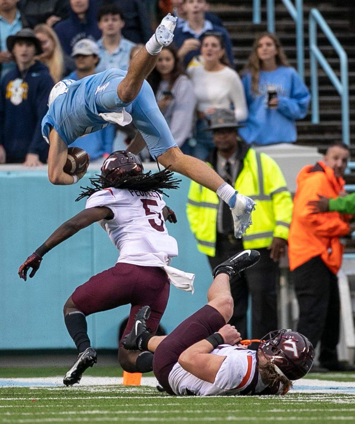 North Carolina quarterback Drake Maye (10) hurdles over Virginia Tech’s Nasir People (5) for a six-yard gain in the third quarter on Saturday, October 1, 2022 at Kenan Stadium in Chapel Hill, N.C. Maye was injured on the play.