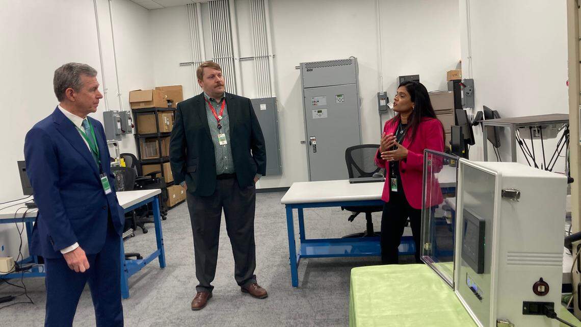 Gov. Roy Cooper listens to a presentation from Schneider Electric employees as he tours the company’s RaleighHub in Morrisville on Wednesday, October 18. Cooper would later make critical remarks of Duke Energy’s latest proposal to slash carbon dioxide emissions, calling for more renewable energy and fewer large-scale resources like proposed small modular nuclear reactors.