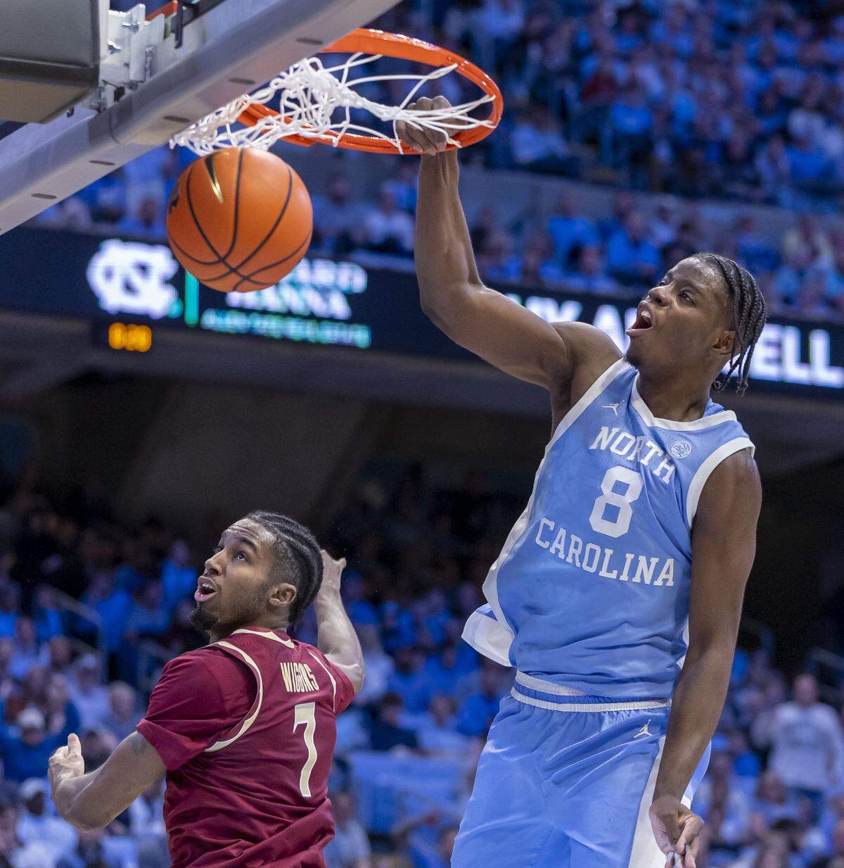 North Carolina forward Caleb Wilson (8) breaks to the basket for a dunk against Florida State forward Chauncey Wiggins (7) in the second half on Tuesday, December 30, 2025 at the Smith Center in Chapel Hill, N.C. Wilson lead all scores with 22 points in the Tar Heels’ 79-66 victory.