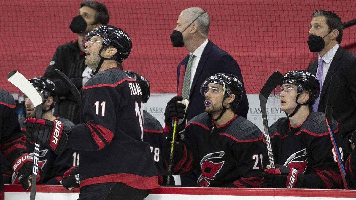Carolina Hurricanes’ captain Jordan Staal (11) and coach Rod Brind’Amour watch the replay of a Columbus goal by Seth Jones (3) in the first period on Thursday, March 18, 2021 at PNC Arena in Raleigh, N.C.