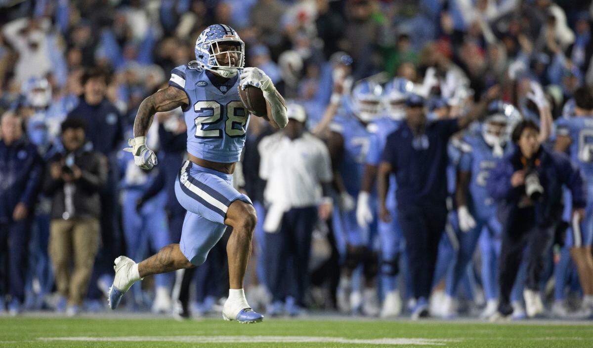 North Carolina running back Omarion Hampton (28) breaks open for a 75-yard touchdown run in the third quarter against N.C. State on Saturday, November 30, 2024 at Kenan Stadium in Chapel Hill, N.C.