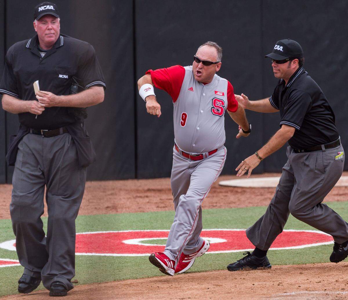 NC State head coach Elliott Avent is thrown out by home plate umpire Scott Higgins for arguing balls and strikes during the Wolfpack's 8 - 1 victory over the Coastal Carolina Chanticleers at Doak Field in 2016.