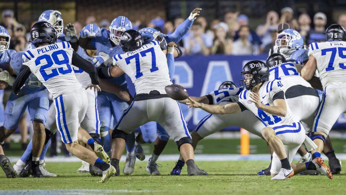 Duke place holder Kade Reynoldson (41) passes the ball to kicker Todd Pelino (29) on a fake field goal attempt, to secure a first down, leading to the game winning touchdown on the series in the fourth quarter, to secure a 32-25 victory over North Carolina on Saturday, November 22, 2025 at Kenan Stadium in Chapel Hill, N.C.