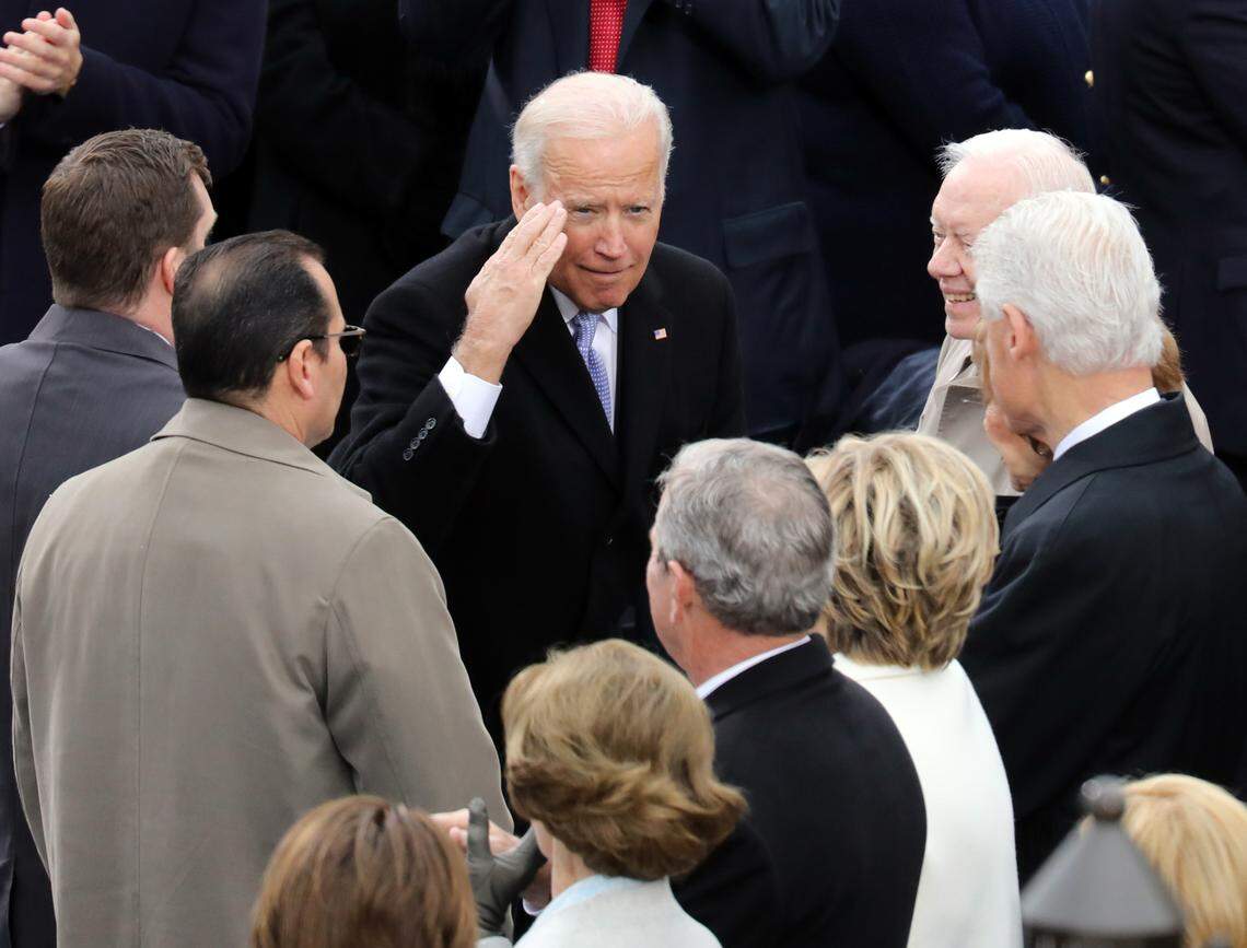Vice President Joe Biden salutes toward former President George W. Bush.