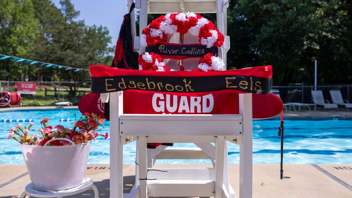 A makeshift memorial for 15-year-old River Collins sits at the base of a lifeguard stand at the Edgebrook Swim Club in Garner, where he worked as a lifeguard, on Friday, June 27, 2025. River, his 13-year-old brother, Jet Collins, and their father, Shannon Collins, 49, were found dead with gunshot wounds inside their home on Rand Road in Raleigh after firefighters and emergency personnel responded to a house fire there Tuesday morning.