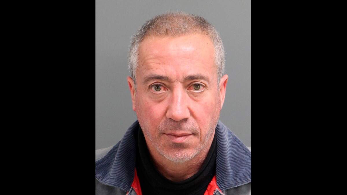 This undated file mug shot provided by the Wake City-County Bureau of Identification shows Christian Desgroux, 58, who’s accused impersonating a federal officer falsely reporting pursuing illegal immigrants carrying a bomb.