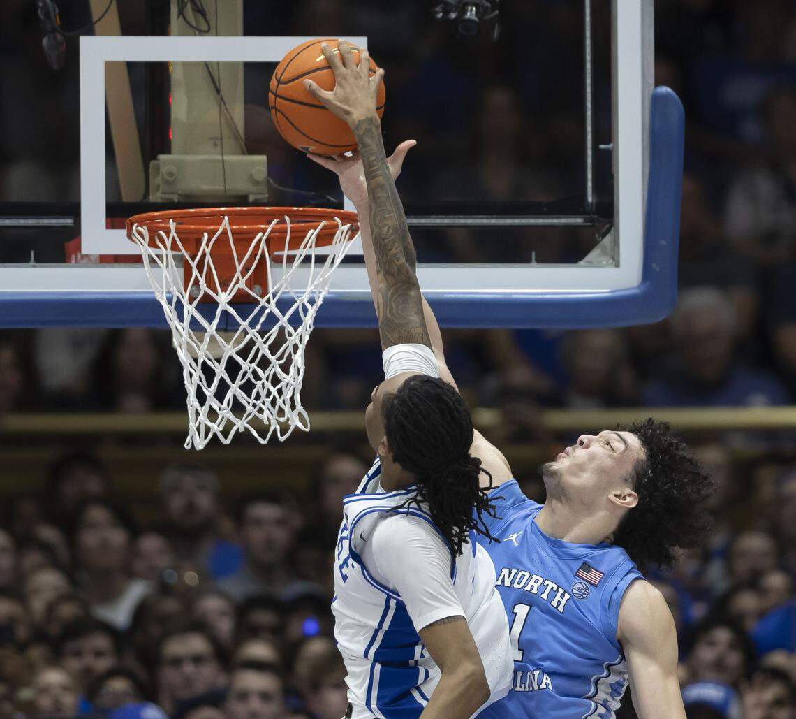 North Carolina forward Zayden High (1) blocks a dunk attempt by Duke forward Isaiah Evans (3) in the second half on Saturday, March 7, 2026 at Cameron Indoor Stadium in Durham, N.C.