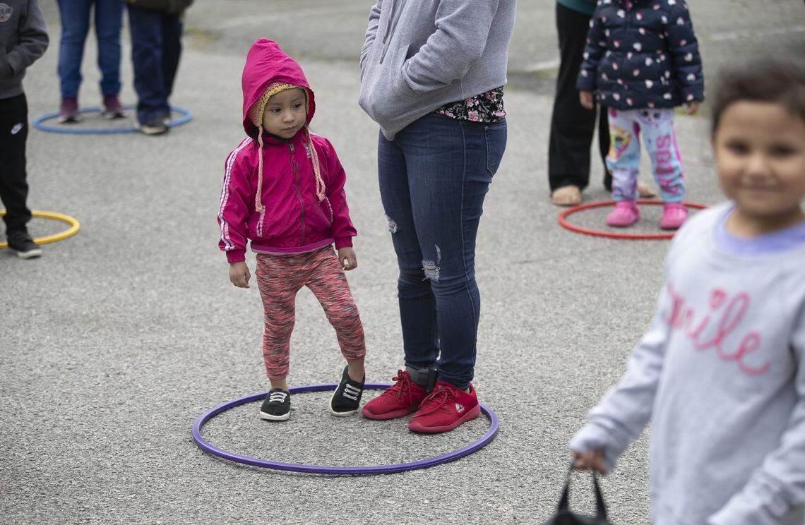 Families practice social distancing as they wait for meals to be distributed by Cary United Methodist Church on Tate Street in Cary, N.C. on Wednesday, April 1, 2020. More than 100 meals were distributed to the largely Latino community on Wednesday.