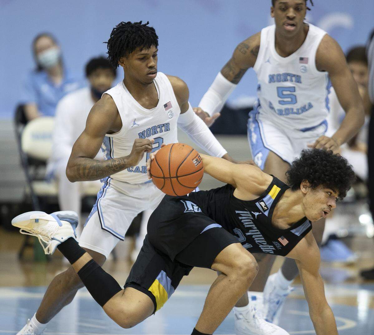 North Carolina’s Caleb Love (2) defends Marquette’s Jamal Cain (23) during the first half on Wednesday, February 24, 2021 at the Smith Center in Chapel Hill, N.C.