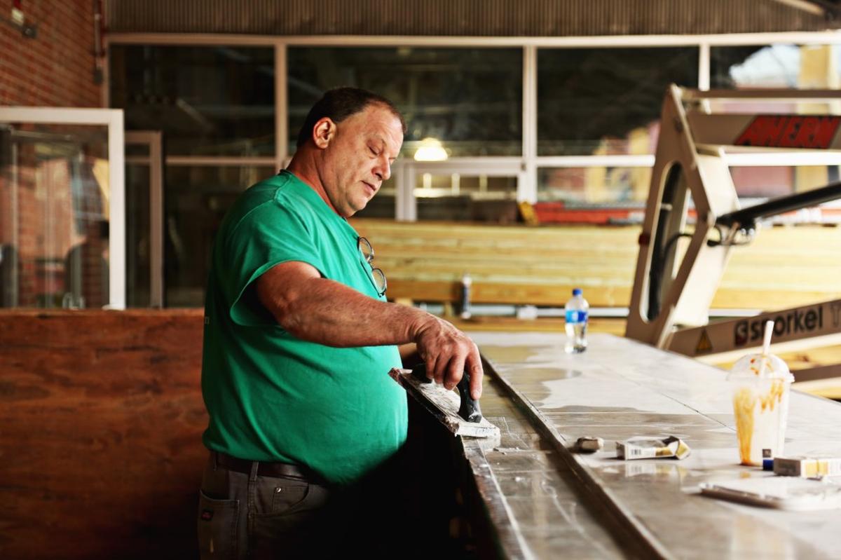 Bobby Hollomon works on the outdoor bar at Morgan Street Food Hall & Market in downtown Raleigh on Feb. 22, 2018. The 20,000 square foot venue will offer a variety of retail and food offerings in a series of stalls as well as an indoor and outdoor bar.