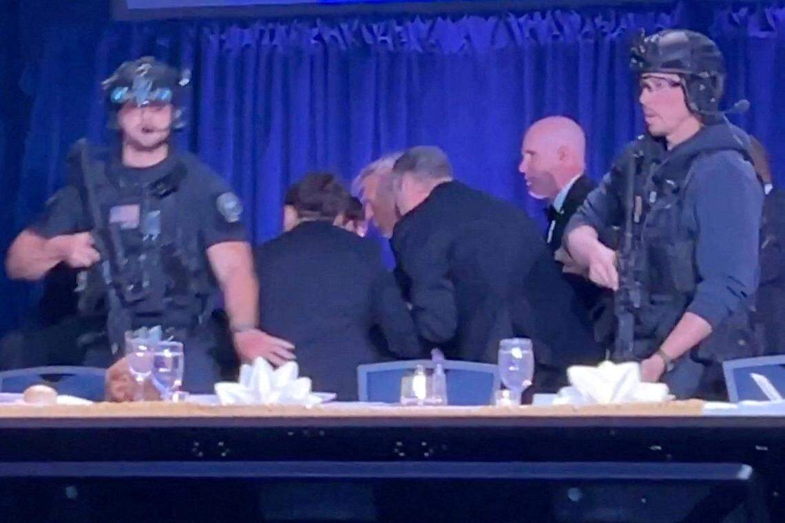 U.S. President Donald Trump is escorted out as a shooter opens fire during the annual White House Correspondents' Association dinner in Washington, D.C., U.S., April 25, 2026, in this screen capture from video. 