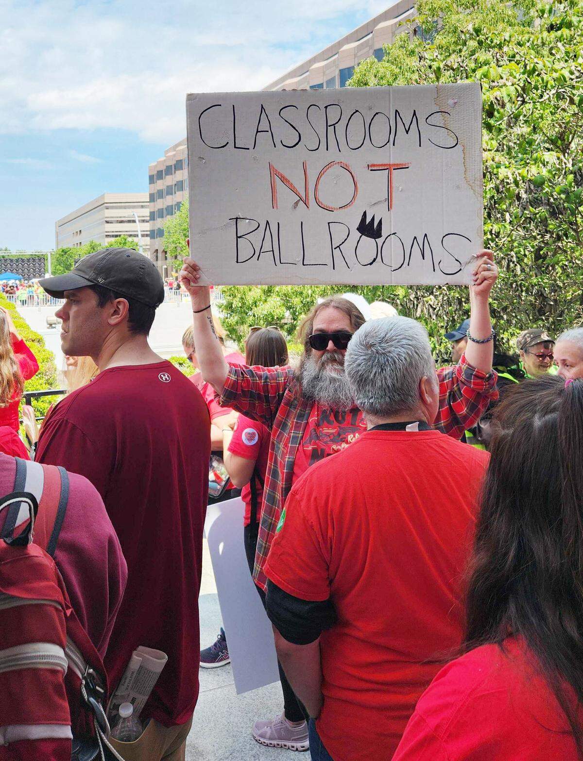 Protesters with signs gather around the Legislature in Raleigh.