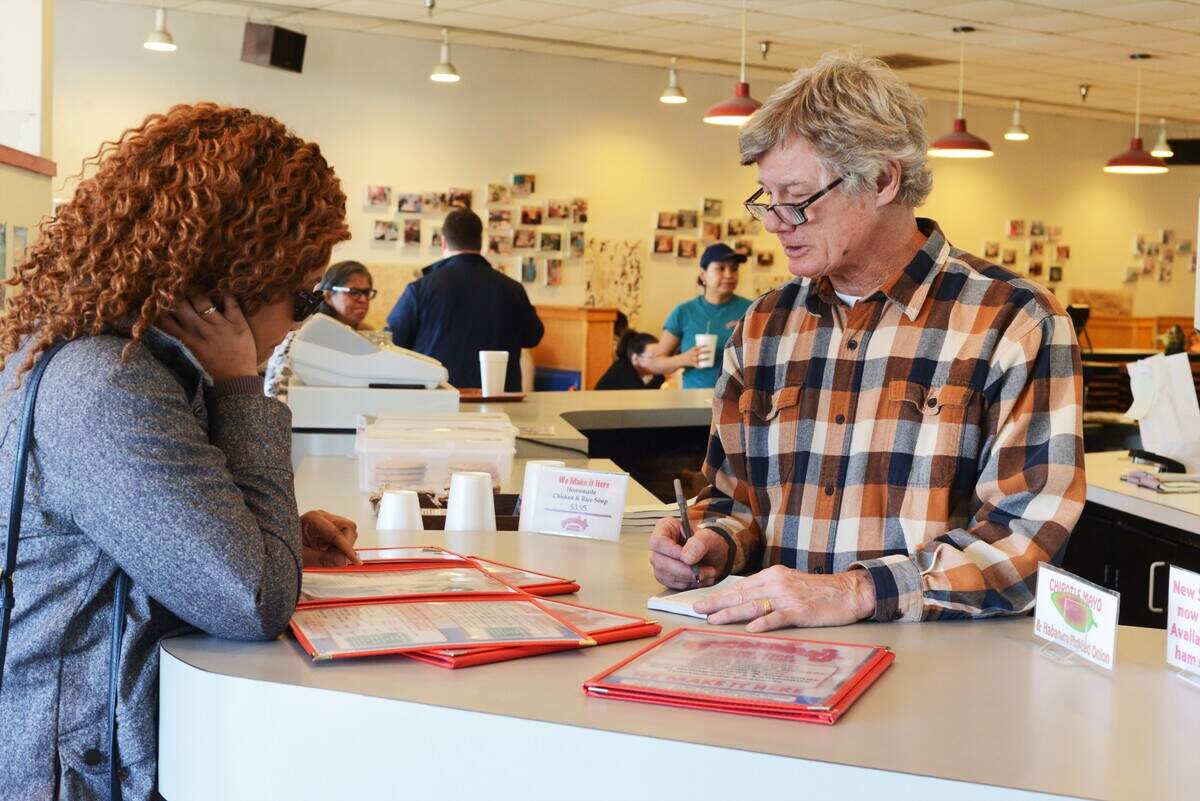 Boondini’s owner Billy Williams takes the sandwich order of newcomer Crystal Carr on one of the restaurant’s last days in business.