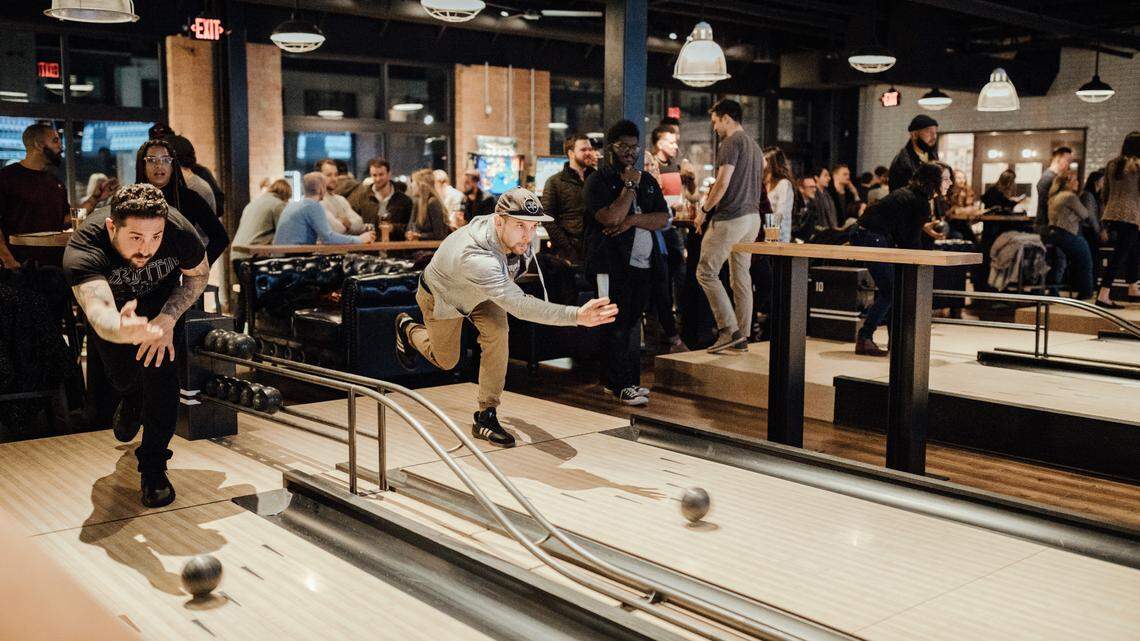 Duckpin bowling, one of the activities featured at Pins Mechanical Co., is similar to traditional bowling. However, players use palm-sized balls to knock down lightweight, shorter pins on shorter lanes.