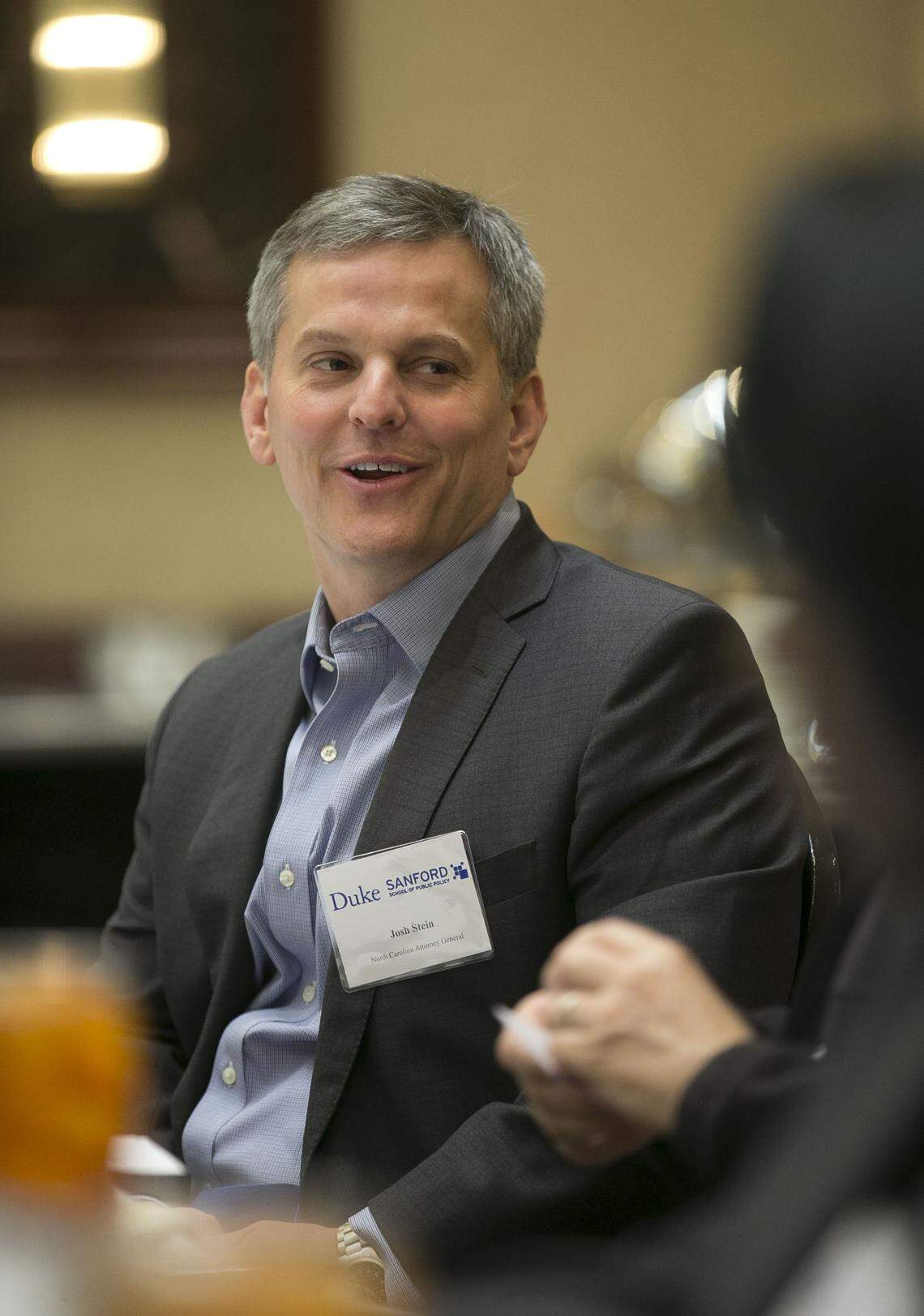 North Carolina Attorney General Josh Stein chats with panel members during a roundtable discussion on the opioid crisis in North Carolina hosted by Duke University on Wednesday, April 11, 2018 in Research Triangle Park, N.C.