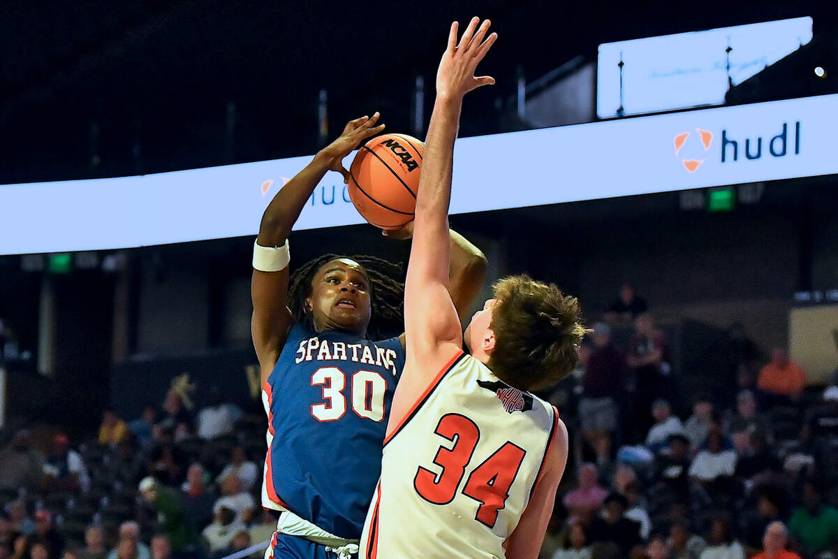 Sanderson’s Malakhi Murphy (30) goes up for the shot against New Hanover’s Nolan Billings (34) during the first half. The Sanderson Spartans and the New Hanover Wildcats met in the NCHSAA 4A East Regional Final in Winston-Salem, N.C. on March 12, 2025.