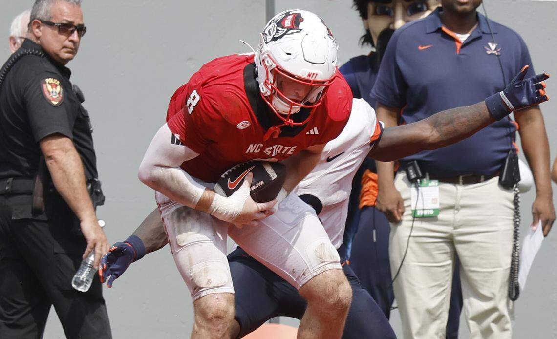 N.C. State linebacker Cian Slone (8) intercepts the ball intended for Virginia running back J'Mari Taylor (3) in the end zone to effectively end the game during N.C. State’s 35-31 victory over Virginia at Carter-Finley Stadium in Raleigh, N.C., Sat. Sept. 6, 2025.