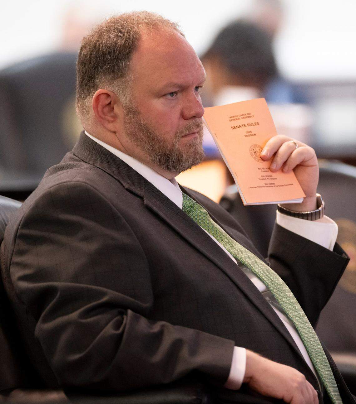 Senator Ralph Hise clutches the Senate Rules book as he listens to Democratic members offering amendments to the Senate budget proposal on Wednesday, April 16, 2025 at the General Assembly in Raleigh, N.C.