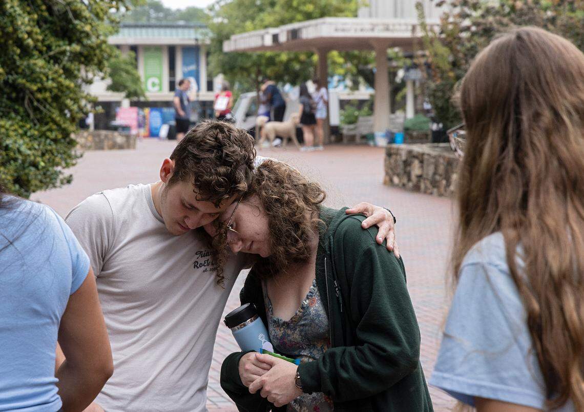 UNC-Chapel Hill first-year students Lucas Moore and Katie Fiore embrace on Tuesday, Aug. 29, 2023, in Chapel Hill, N.C. following a Monday shooting that left a faculty member dead on the university’s campus.