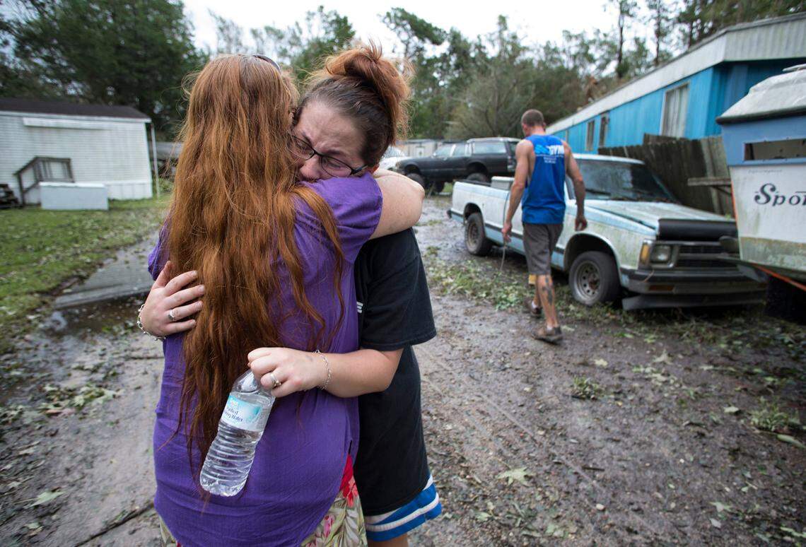 Hillary Priddy embraces her neighbor Renee Askew in their mobile home park along Nine Foot Road in Newport, N.C. on Sunday, September 16, 2018. Askew lost her home and all of her possessions after Hurricane Florence flooded her home on Friday night. The water rose so quickly from tributaries of the Newport River that Askew had to escape from a window in her mobile home and swim to safety. 